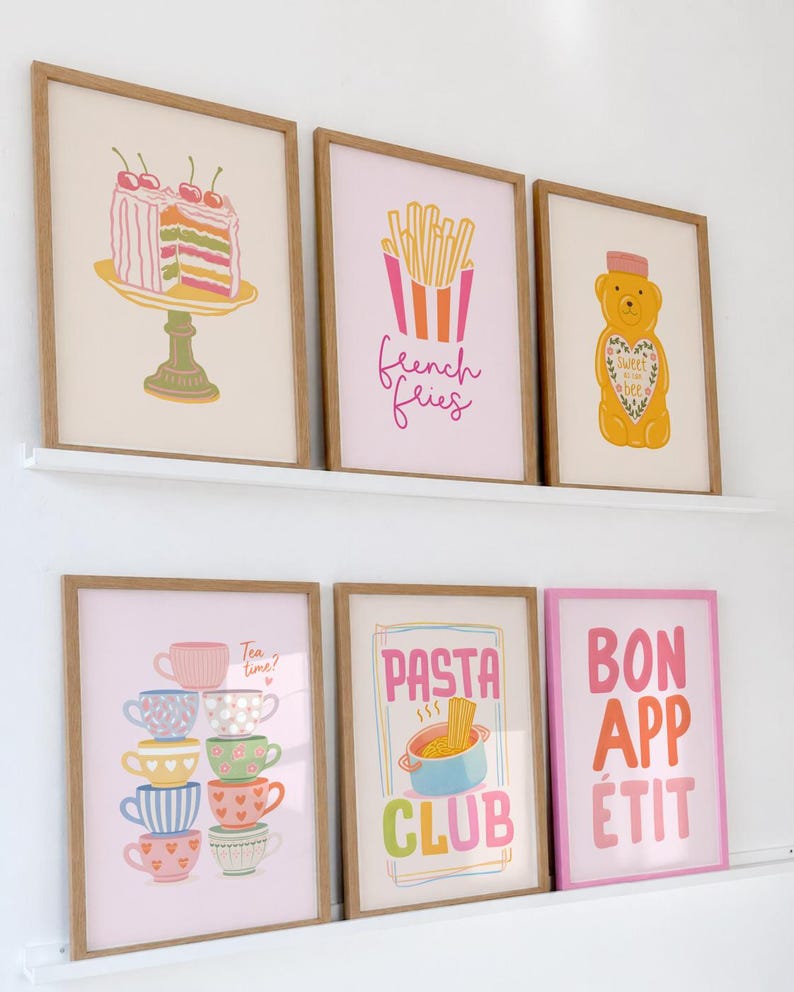 May include: Six framed art prints with food-themed illustrations. Prints include a cake, French fries, a bear, stacked teacups with "Tea time?" text, pasta with "Pasta Club" text, and "Bon App&eacute;tit" text.