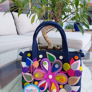 Felt handbag/crossbody bag colorfully decorated.