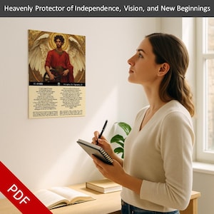 May include: A framed print featuring an angel with wings, wearing a red robe, and holding a wheel. The print includes text at the bottom and is hanging on a white wall. A person is looking at the print while holding a pen and notebook.