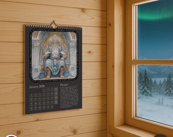 May include: A black wall calendar for January 2026, featuring an illustration of a seated figure in blue and gold. The calendar is hanging on a wooden wall near a window with a snowy landscape and aurora borealis.