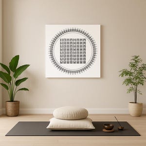 May include: A square canvas art piece with a circular design in black and white hangs on a beige wall. A yoga mat, two beige cushions, a small bowl, and a plant are on the floor. A plant in a woven basket is on the left, and a plant in a pot is on the right.