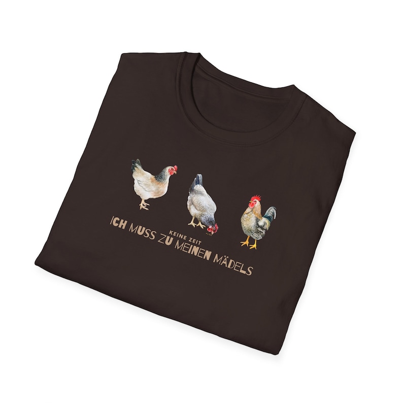 May include: A brown t-shirt with a graphic of three chickens and the text "Keine Zeit Ich Muss Zu Meinen M&auml;dels".