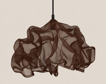 May include: A dark brown pendant light fixture featuring a sculptural, cloud-like shade made from a fine, semi-transparent mesh material. The shade is suspended from a thin, straight black rod that connects to the top center of the structure.