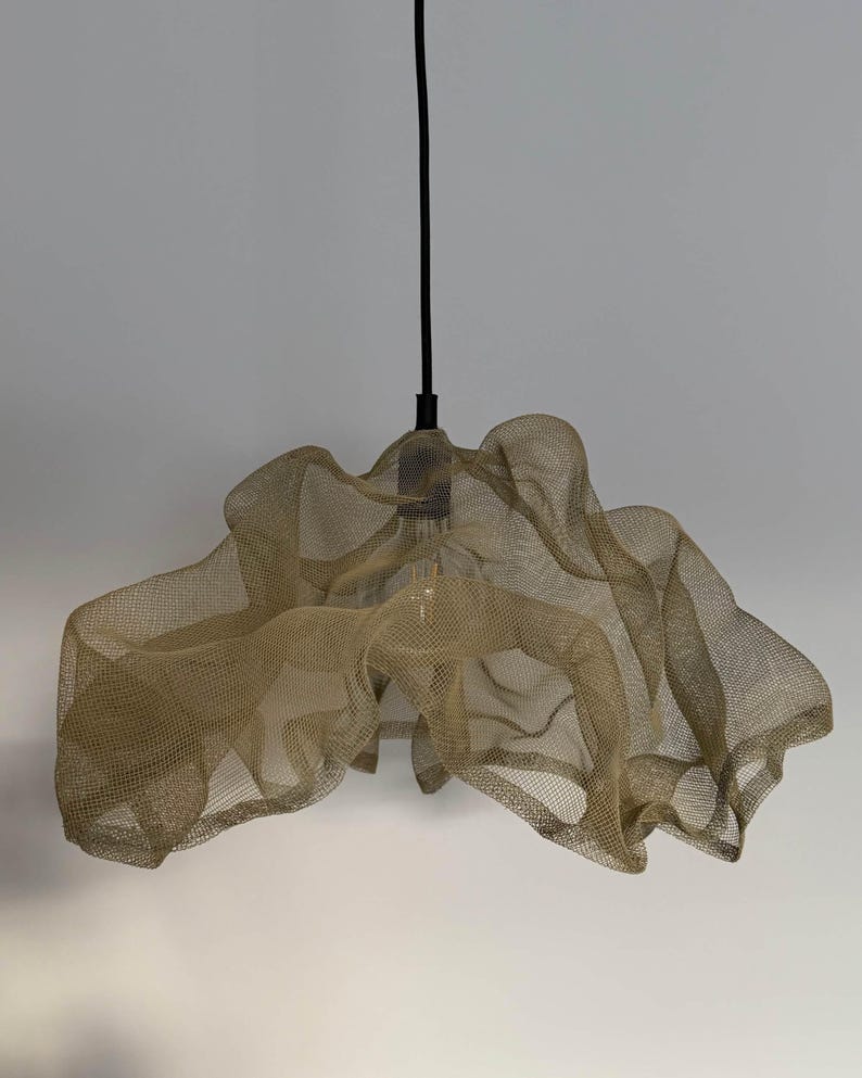Handcrafted sand-colored wire mesh pendant light casting soft shadows in a modern space.