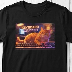 Illustrated cat lounging across a computer keyboard, paws stretched over the keys, with a contented expression. Funny cat lover graphic printed on a t-shirt