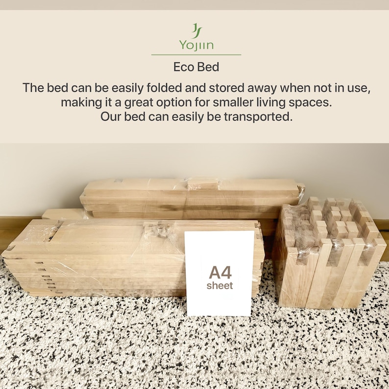 May include: An Eco Bed, disassembled and wrapped in clear plastic, ready for assembly. The wooden components are arranged on a patterned rug, with an A4 sheet for scale. The bed is designed for easy folding and storage.