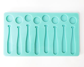May include: A teal silicone mold featuring baseball bat and ball shapes. The mold has eight bat shapes and eight circular shapes, perfect for crafting themed treats or decorations. The design is simple and clean, ideal for various crafting projects.