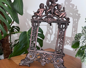 A solid heavy cast iron ornate antique  frame likely from the boroque revival or Victorian era gorgeous copper patinated finish