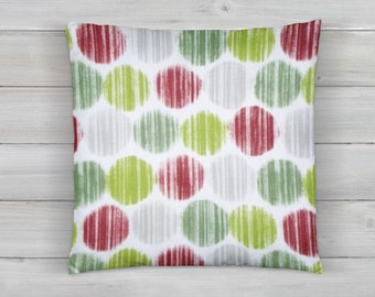 May include: Square throw pillow with a white background and a pattern of large, colorful circles. The circles are filled with vertical lines in red, green, and gray.