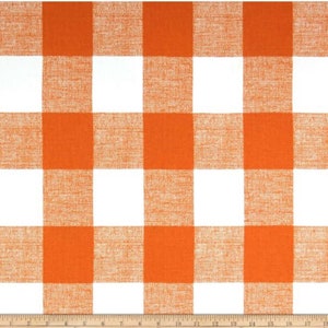 May include: Orange and white checkered fabric with a woven texture. The fabric is shown with a measuring tape.