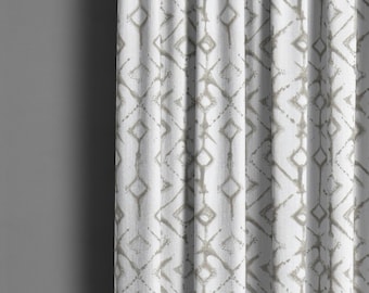 May include: White curtain with a repeating geometric diamond pattern in a muted gray color. The fabric is textured, and the curtain is partially drawn, showing vertical folds. The design is simple and modern.