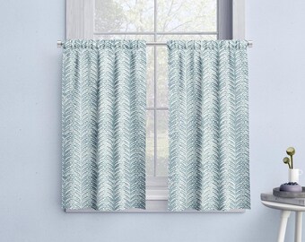May include: A pair of white valance curtains with a blue and white geometric pattern. The curtains are hung on a white window frame.