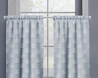 May include: A pair of light blue curtains with a white leaf pattern. The curtains are hung on a silver rod.