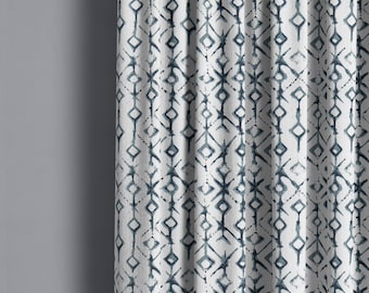 May include: White fabric curtain with a blue geometric pattern. The pattern is made up of diamonds and lines.