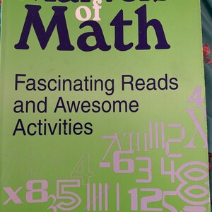 May include: A green book cover with the title "Marvels of Math" in large blue letters. The subtitle is "Fascinating Reads and Awesome Activities". The cover also features a variety of numbers and mathematical symbols in a light pink color.