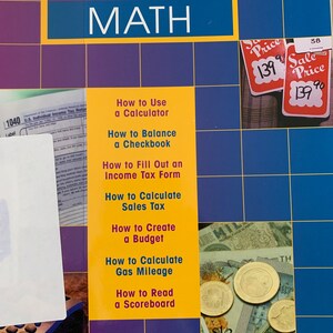 May include: A yellow book titled "Real-Life Math" with a grid pattern on the cover. The book lists several topics including how to use a calculator, balance a checkbook, fill out an income tax form, calculate sales tax, create a budget, calculate gas mileage, and read a scoreboard.