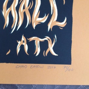May include: A print with the words "WHALE, ATX" in white and tan against a dark blue background. The print is signed "CHAD EATON 2016" and numbered 70/100. The background is tan.