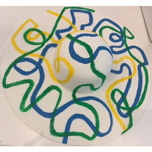 Unique floppy hat, hand  painted, crafted with. Blend of 3 colors. And can be worn fir many occasions. She’s ready