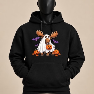 May include: A black hooded sweatshirt featuring a graphic of a moose wearing a white ghost costume, holding an orange jack-o'-lantern bucket, surrounded by two additional jack-o'-lanterns and three purple bats. The text Made You Wear It is visible.