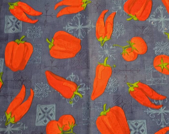 Red vegetables on royal blue cotton fabric