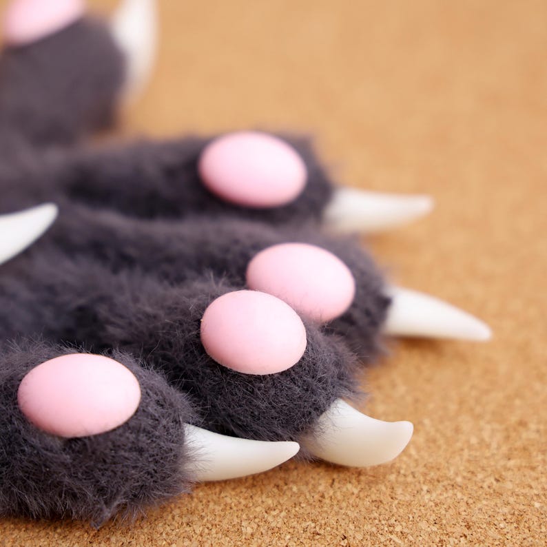 Soft & Realistic Furry Paw Gloves, Beast Hands for Cosplay & Costume Events – These cosplay beast hands feature lifelike 3D-printed claws, ultra-soft plush fur, and squishy silicone pads, making them perfect for furry conventions, anime events, and roleplaying. The gloves come with adjustable wrist straps for a comfortable fit. Choose from black, white, gray, or pink to match your desired character style. Ideal for Halloween, costume parties, and performances.