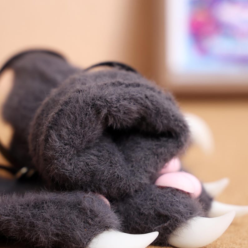 Furry Beast Paws for Fursuit, Costume & Anime Cosplay, Silicone Pad Gloves – These realistic furry paw gloves are crafted for cosplayers, fursuit enthusiasts, and costume makers. The high-quality plush fur ensures softness, while the 3D-printed claws and squishy silicone pads enhance realism. Adjustable wrist straps guarantee a secure and comfortable fit, making them suitable for conventions, roleplay events, and themed parties. Available in multiple color options.