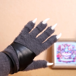 Realistic Cosplay Paw Gloves with Claws, Soft Plush Fur & Silicone Pads – Perfect for fursuits, cosplay, and roleplay, these furry beast gloves offer ultra-soft plush material, realistic 3D-printed claws, and silicone pads for an authentic touch. Whether you're attending a furry convention or doing a themed photoshoot, these gloves provide the perfect finishing touch to your outfit. Adjustable straps ensure a snug and comfortable fit for different hand sizes.