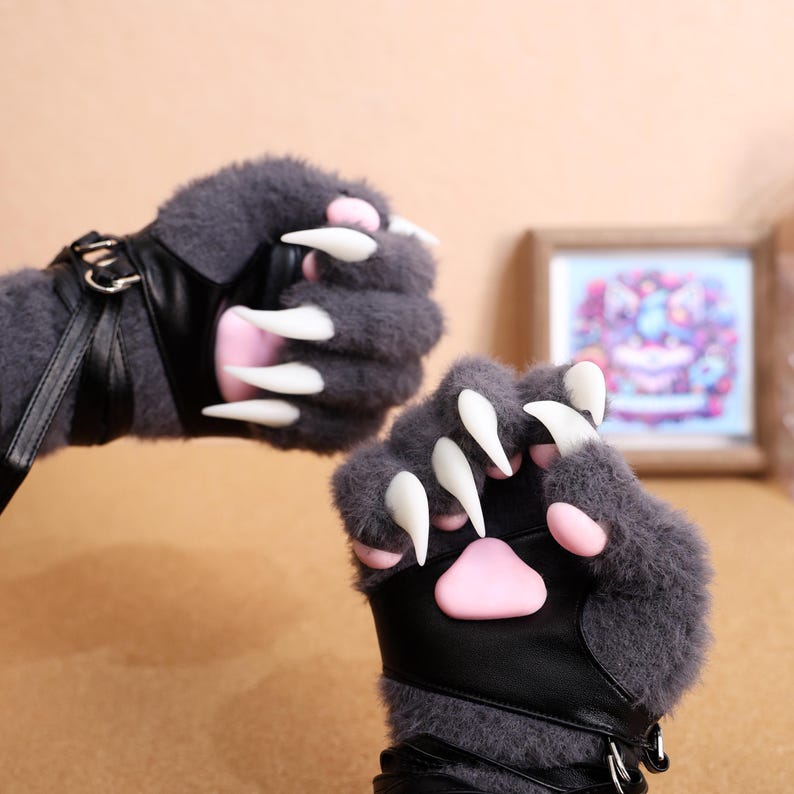 Furry Paw Gloves with Silicone Pads & 3D Printed Claws, Cosplay Beast Hands – These ultra-soft plush furry gloves feature lifelike 3D-printed claws and squishy silicone pads, perfect for cosplay, fursuits, and costume roleplay. The Kig-style design enhances your anime or fantasy character, making them ideal for furry conventions, photography, and themed parties. Adjustable wrist straps ensure a comfortable fit. Available in black, white, gray, and pink.