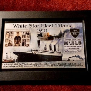 May include: Framed print of the White Star Fleet Titanic from 1912. The image includes the ship, passengers, and the text "BAND PLAYED TILL END." The print is in a black frame.
