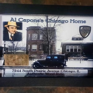 May include: Framed image featuring Al Capone's Chicago Home. The image includes a portrait of Al Capone, a vintage car, and the address 7244 South Prairie Avenue Chicago, IL. The frame is black.