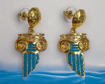 May include: Gold tone earrings with a blue enamel design of a Greek column. The earrings have a hammered texture.