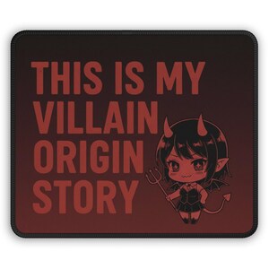 May include: A rectangular mousepad with a red and black gradient background. The text "THIS IS MY VILLAIN ORIGIN STORY" is printed in red. A cartoon devil girl with horns, wings, and a trident is on the right.