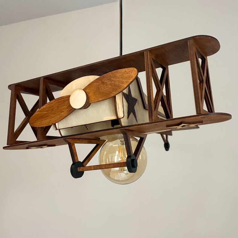 Handmade wooden airplane lamp in natural wood – vintage biplane nursery decor.
