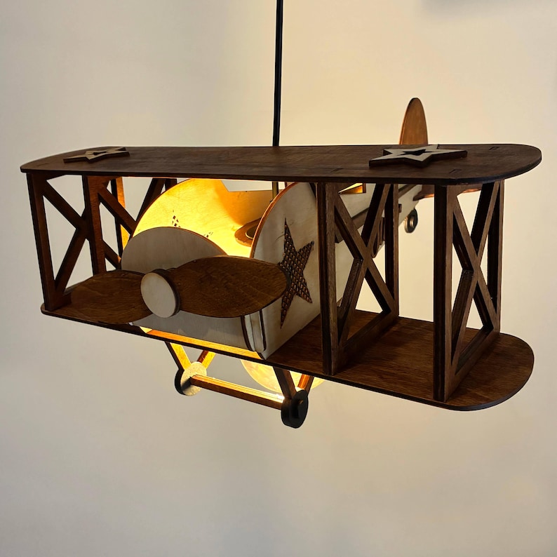 Wooden biplane airplane ceiling lamp with warm glow – cozy nursery night light.