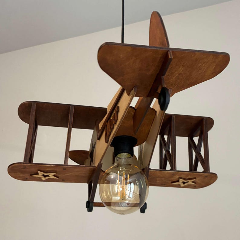 Wooden biplane airplane lamp in natural wood and teak tones – handmade nursery and kids decor.