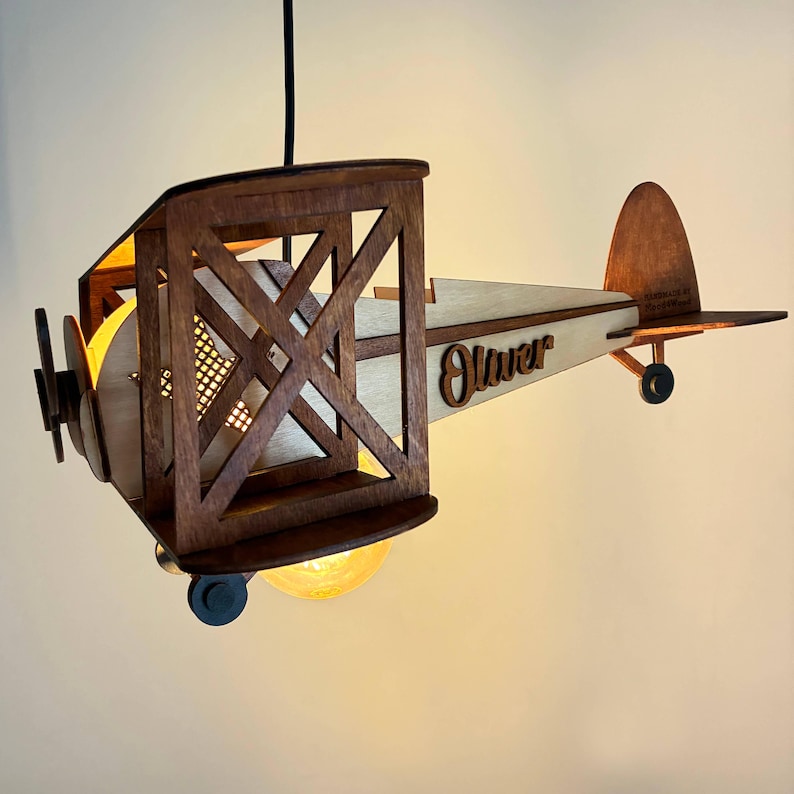 Handmade wooden airplane lamp with warm light – vintage biplane nursery night light.