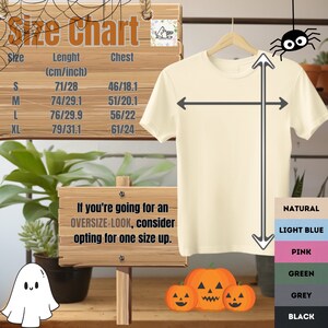 May include: Size chart for a t-shirt with measurements in centimeters and inches. The chart shows the length and chest measurements for sizes S, M, L, and XL. The t-shirt is shown in natural color. The text "If you're going for an OVERSIZE-LOOK, consider opting for one size up." is displayed below the chart. The image also shows a variety of color options for the t-shirt, including natural, light blue, pink, green, grey, and black.