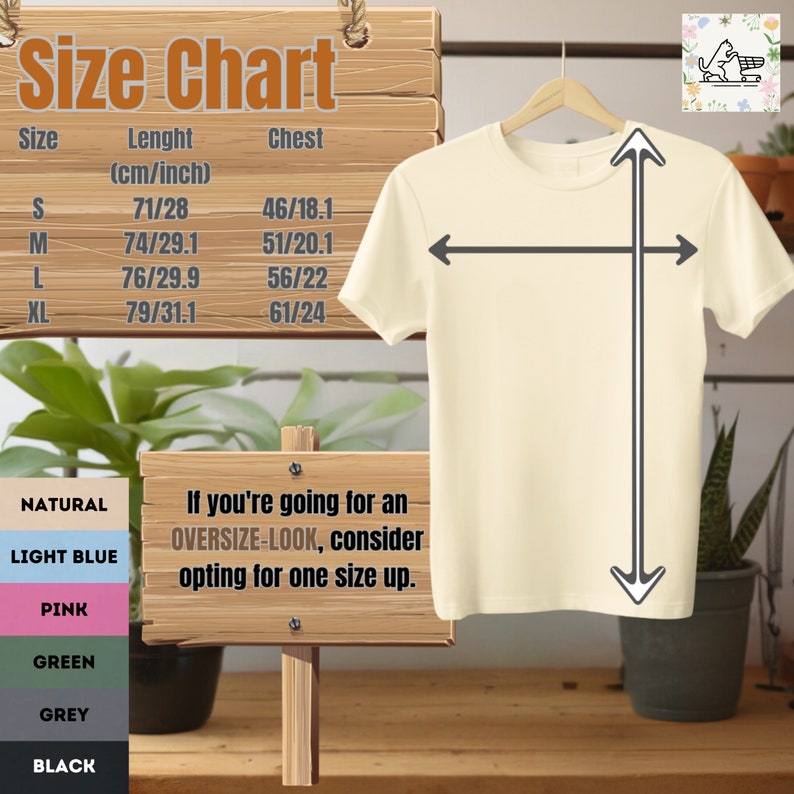 May include: A cream-colored t-shirt hangs on a wooden hanger, with size chart details and measurements in inches and centimeters. The chart includes sizes S, M, L, and XL, with chest and length measurements. A sign advises sizing up for an oversized look.