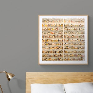 May include: A framed photograph of a wall filled with small glass jars containing various spices and herbs. The jars are arranged in rows and columns, creating a visually appealing pattern.