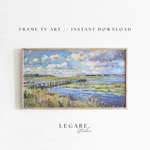 May include: A framed painting depicting a landscape with a wooden jetty stretching out into a body of water. The sky is blue with white clouds and the water is a light blue. The foreground is a field of green grass.