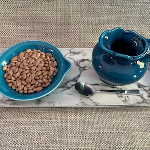 Practical Life Montessori Materials for Spooning and Pouring Extension Activity with Blue Ceramic Bowl and Pitcher and a Marble Look Tray