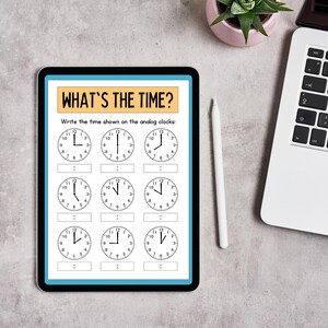 May include: A digital tablet displaying a worksheet with the title "What's the Time?" and nine analog clocks with blank spaces to write the time. The worksheet instructs the user to "Write the time shown on the analog clocks."