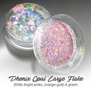 May include: Two clear jars filled with iridescent opal flakes. The flakes shift colours from pink, orange, and gold to green.