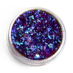 May include: A small clear jar filled with iridescent blue and purple glitter.