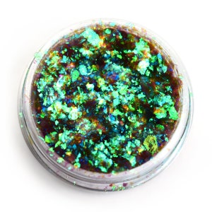 May include: A small clear jar filled with iridescent green and blue glitter. The glitter is loose and has a metallic sheen.
