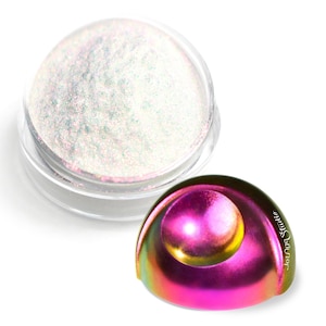 May include: A small jar of iridescent white glitter powder. The jar is clear and has a black lid. The glitter is very fine and has a pearlescent finish. The jar is sitting on a white surface.