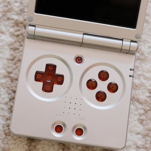 Anbernic RG35XXSP Transparent Orange Buttons