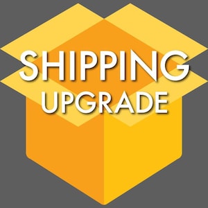May include: An illustration of an open box in yellow and orange hues, with the words "SHIPPING UPGRADE" in white, bold text. The background is a solid grey colour.
