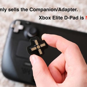 May include: Black and gold D-pad companion/adapter held in hand, with a black game controller in the background. The text in the image states that the Xbox Elite D-Pad is not included.