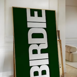 May include: A green poster with the word "BIRDIE" in white letters.